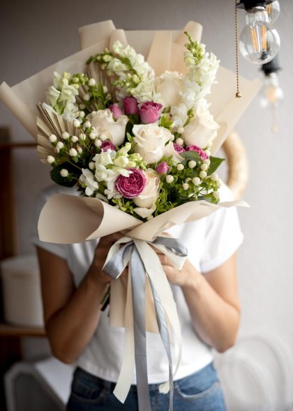 medium-shot-hands-holding-flowers