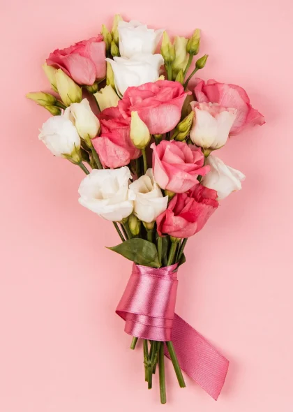 top-view-beautiful-roses-bouquet-with-pink-ribbon